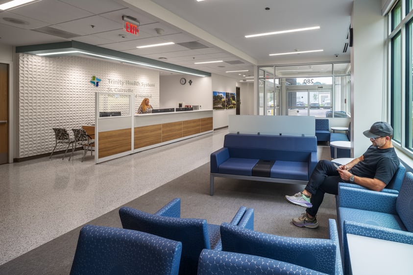 Main reception and registration area with a check-in desk, integrated patient service counters and adjacent waiting space.